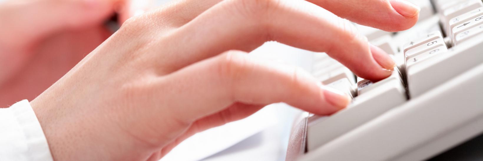 Typing on computer.